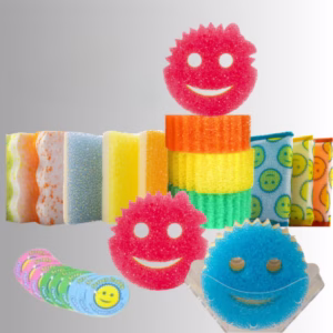A promotional product hero image of a massive 17-piece Scrub Daddy variety bundle set against a neutral gradient background, showcasing an assortment of colorful face-shaped sponges, stacked scouring pads, patterned cloths, and a stack of round scrubbers with smiling faces.