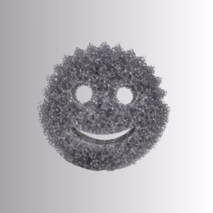 Image Description: A promotional product hero image of a classic smiley-face scrubbing sponge in a textured metallic dark grey or charcoal finish, set against a neutral gradient background.