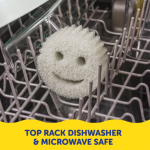 Image Description: A lifestyle product photo featuring a pair of hands rinsing a grey textured smiley-face sponge under a kitchen faucet with running water, accompanied by yellow text at the bottom that reads "Rinses Clean Under Running Water".