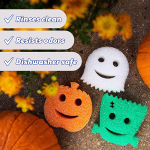 Scrub Daddy Halloween Shapes Non-Scratch Sponges (3 Individual Boxes) arranged outdoors on a stone surface with pumpkins and autumn flowers, highlighting benefits like rinses clean, resists odors, and dishwasher safe