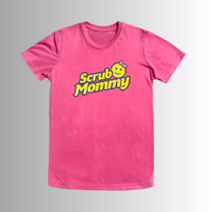 mage Description: A promotional product hero image of the front of a vibrant pink short-sleeve t-shirt set against a neutral gradient background, featuring the yellow and blue "Scrub Mommy" logo with a pink bow graphic printed across the chest.