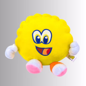 Image Description: A promotional product hero image of a soft yellow Scrub Daddy plush toy set against a neutral gradient background, featuring embroidered blue-and-white eyes, a smiling mouth, white-gloved hands, and pink-and-white feet.