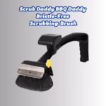 Image Description: A promotional hero image for the "Scrub Daddy BBQ Daddy Bristle-Free Scrubbing Brush," featuring bold blue header text at the top against a neutral gradient background, showcasing the black BBQ Daddy grill tool equipped with a stainless steel scraper and a textured scrubbing head.