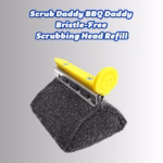 Image Description: A promotional product hero image featuring bold blue text at the top that reads "Scrub Daddy BBQ Daddy Bristle-Free Scrubbing Head Refill," displayed over a neutral gradient background showcasing a single black bristle-free scrubbing head replacement unit with a yellow smiley face release knob and mounting bracket.