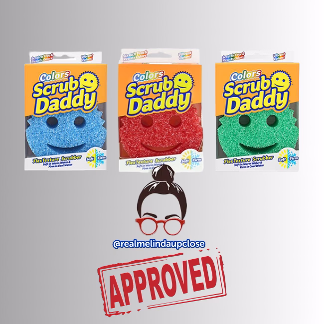 Image Description: A promotional product bundle hero image featuring three boxed Scrub Daddy Colors sponges in blue, red, and green arranged in a row above an approved creator stamp graphic.