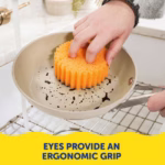 Image Description: A product feature infographic showing a hand using an orange Scrub Daddy sponge to wash a pan over a sink, highlighting the ergonomic grip provided by the sponge's eye holes.