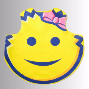 Image Description: A promotional product hero image of a yellow Scrub Mommy costume tunic set against a neutral gradient background, featuring the classic smiley face graphic with blue eyes and a smiling mouth, a blue jagged border at the top and sides, and a prominent pink bow with blue outline on the upper right.