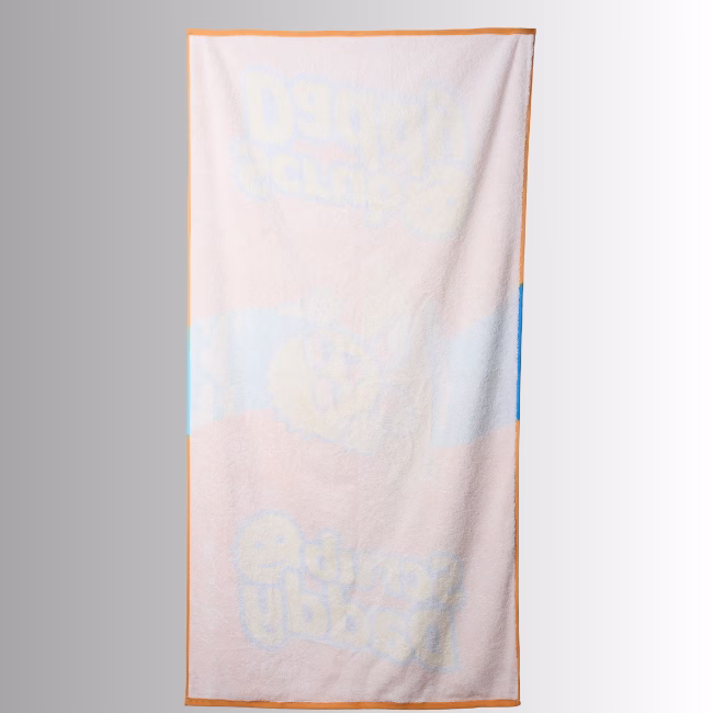 Image Description: A promotional product image showing the reverse side of the vibrant orange Scrub Daddy beach towel set against a neutral gradient background, featuring a lighter, muted reverse print of the central surfing character graphic and surrounding brand lettering.