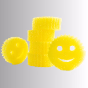 Image Description: A promotional product hero image of a vertical stack of four yellow original Scrub Daddy sponges next to two individual smiley-face sponges set against a neutral gradient background.
