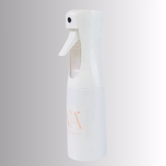 Image Description: A promotional product photo of the white continuous spray bottle from a full side angle set against a neutral gradient background, displaying the complete silhouette and brand logo.