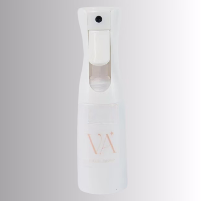 Image Description: A promotional product hero image of a white continuous spray bottle set against a neutral gradient background, featuring a trigger spray handle and the "VA" logo on the body.