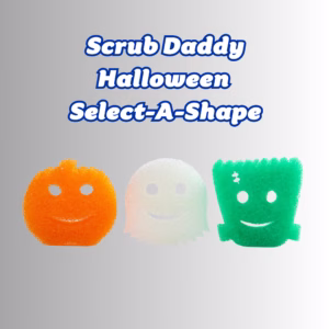 Image Description: A promotional graphic with large blue text at the top that reads "Scrub Daddy Halloween Select-A-Shape" against a neutral gray and white gradient background. Below the text, three Halloween-themed Scrub Daddy sponges are lined up horizontally: an orange pumpkin on the left, a white ghost in the center, and a green Frankenstein's monster with a stitched scar on the right.