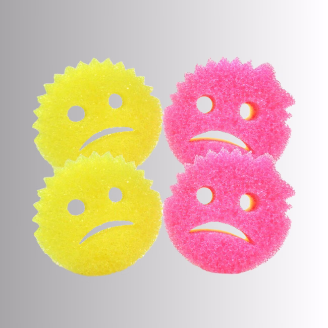 Cranky Couple Hero Image Description: A promotional product bundle hero image set against a neutral gradient background, showcasing a 4-pack of dual-colored Cranky Couple scrub sponges featuring two yellow and two pink sponges with frowning facial expressions.
