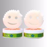 Image Description: A promotional product hero image set against a neutral gradient background, showcasing a 2-pack bundle of Scrub Daddy Power Paste featuring two round tubs of all-purpose cleaning paste topped with matching face-shaped white scrubbing sponges.