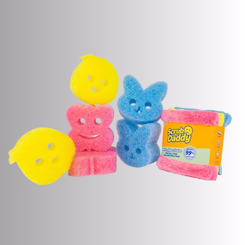 Spring 7-pack Image Description: A collection of spring-themed Scrub Daddy products displayed against a neutral background, including a stack of yellow lemon or chick-shaped sponges on the left, a stack of pink flower-shaped sponges in the center, a stack of blue bunny-shaped sponges on the right, and a folded pack of colorful Scrub Daddy microfiber cloths next to them.