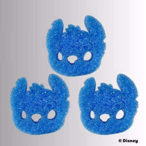 Scrub Daddy Disney Stitch Sponges (3-Pack) displayed against a gradient grey background. Three identical blue Stitch-shaped character sponges are arranged in a triangle formation, featuring textured blue FlexTexture foam with cutouts for eyes and nose. The copyright "© Disney" appears in the bottom right corner.