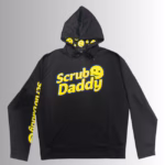 Image Description: A promotional product hero image for a black Scrub Daddy branded hoodie set against a neutral gradient background, featuring the yellow Scrub Daddy logo on the chest, matching yellow branding text down the right sleeve, and a hood interior lined with a yellow smiley face pattern.