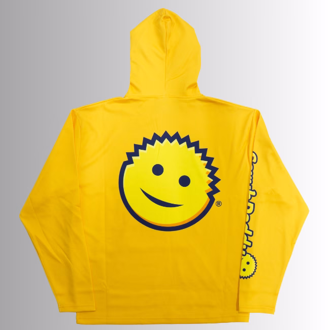 Image Description: A promotional product hero image showing the back of the bright orange Scrub Daddy hoodie set against a neutral gradient background, featuring a large yellow smiley face graphic centered on the back and yellow branding text running down the sleeve.