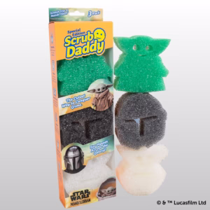 Scrub Daddy Star Wars: The Mandalorian and Grogu Sponges (3-Pack) packaging and loose sponges displayed against a light grey background. On the left is the special edition retail box featuring Star Wars and Mandalorian branding. Stacked vertically to the right are the three character-shaped sponges: a green Grogu sponge at the top, a dark grey Mandalorian helmet sponge in the middle, and a white Grogu in the hover pram sponge at the bottom. The copyright "© & ™ Lucasfilm Ltd" appears in the bottom right corner.