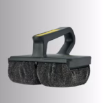 Image Description: A promotional product hero image set against a neutral gradient background, showcasing a black Scrub Daddy Griddle Daddy cleaning tool featuring an ergonomic handle with yellow detailing and dual textured scrubbing pads underneath.