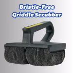 Image Description: Scrub Daddy BBQ Daddy Bristle-Free Griddle Scrubber shown against a gradient grey background. The black tool features an ergonomic handle with a yellow grip stripe on top and two textured ArmorTec mesh scrubbing pads on the bottom. Bold text overlaid at the top reads: "Bristle-Free Griddle Scrubber".