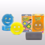 Five Scrub Daddy cleaning products arranged on a light grey background, representing the Roommate Rescue 5-Piece Dorm Cleaning Bundle. The items include a blue tub of PowErase Gel with a blue Scrub Mommy sponge resting on top, a classic yellow Original Scrub Daddy sponge in the front, a 3-pack of Screen Daddy microfiber pads in orange packaging, a clear Daddy Caddy sponge holder in orange packaging, and a grey, ridged Damp Duster tool in the bottom right foreground.
