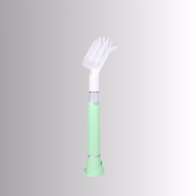 Image Description: A promotional product side image of the Scrub Baby bristle brush set against a neutral gradient background, featuring a light green and white soap-dispensing wand with a white bristle head.