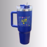 Image Description: A promotional product hero image of a royal blue insulated travel tumbler set against a neutral gradient background, featuring a sturdy side handle, a clear lid with a blue straw and sliding closure, and a vibrant multi-colored doodle graphic square with the "Scrub Daddy" logo on the front.